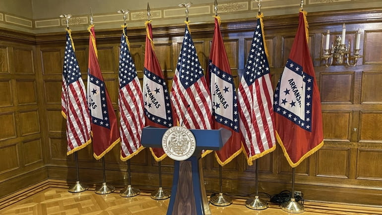 A blue and wood-paneled lectern sits in the governor's conference...