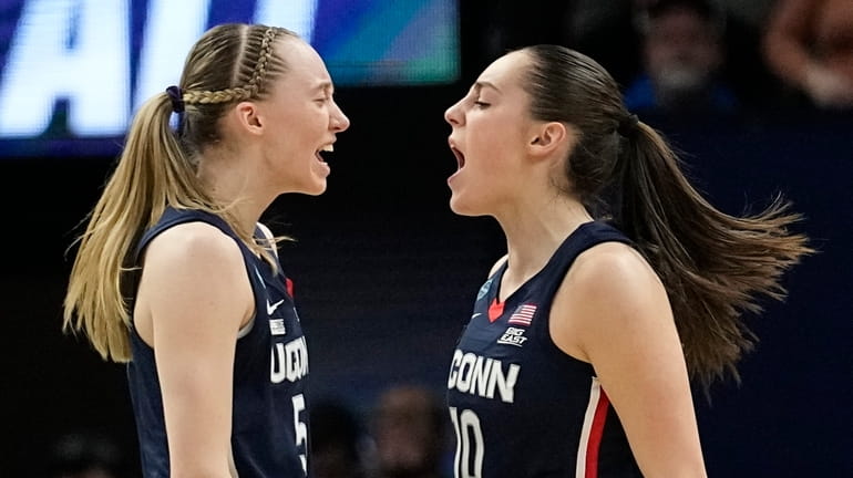 UConn's Nika Muhl is congratulated by Paige Bueckers after a...