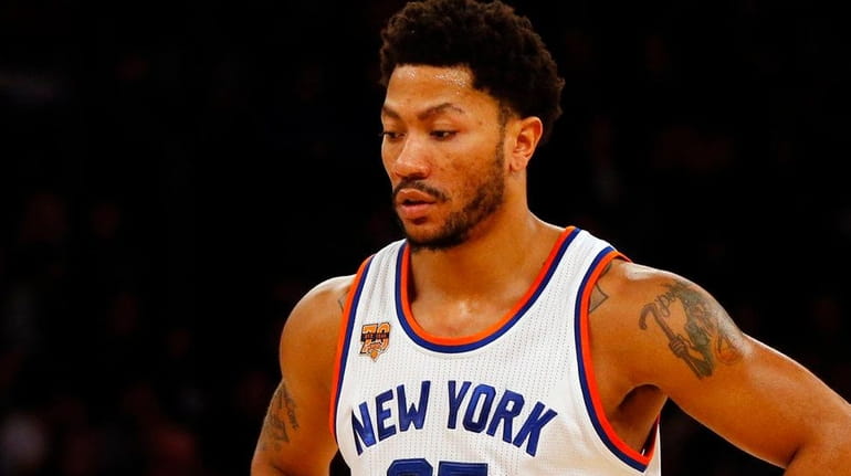 Derrick Rose of the New York Knicks looks on during...
