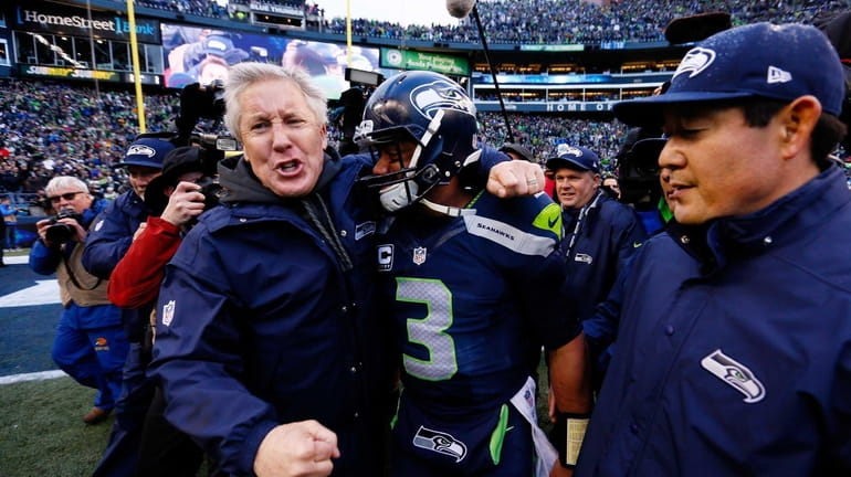 Head coach Pete Carroll and Russell Wilson of the Seattle...