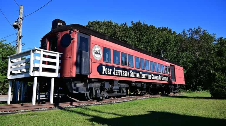 A restored vintage LIRR train car greets visitors to the...