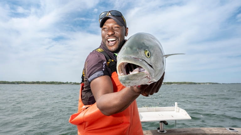 Jermaine Owens holds a 10-pound bluefish caught in the Peconic...
