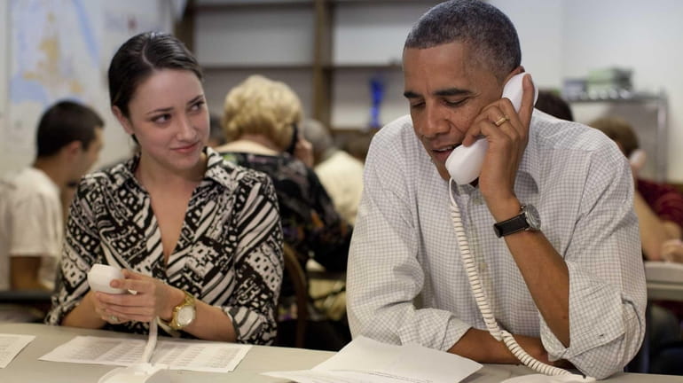 President Barack Obama makes phone calls to volunteers at an...