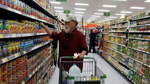 Consumers shop for canned goods at the new Walmart Neighborhood...