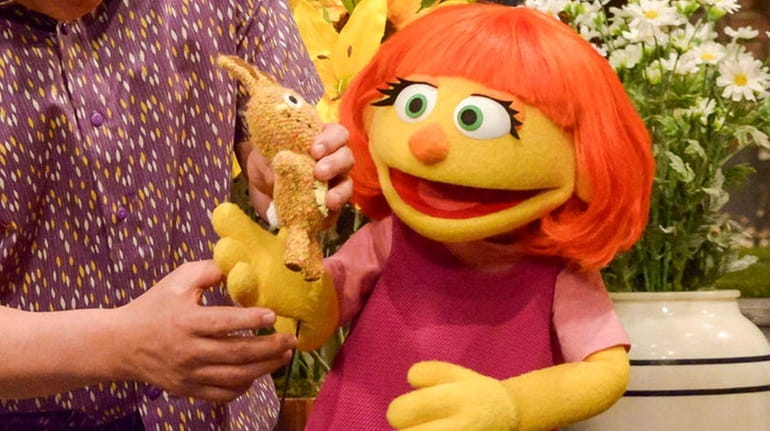 Julia, right, is a new autistic Muppet character debuting on...