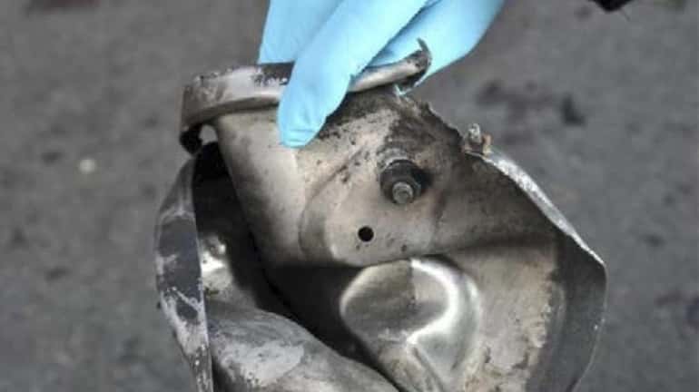 The remains of a pressure cooker that investigators say was...