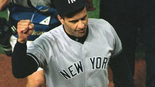 Yankees manager Joe Torre raises his fist as he celebrates...