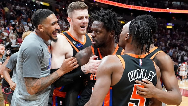 Knicks forward Julius Randle, center, celebrates with teammates after he...