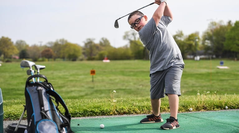 Declan Stack, 7, of Hicksville, who golfs with the PGA...