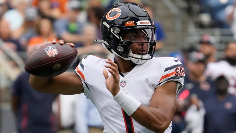 Chicago Bears quarterback Justin Fields passes during the first half...