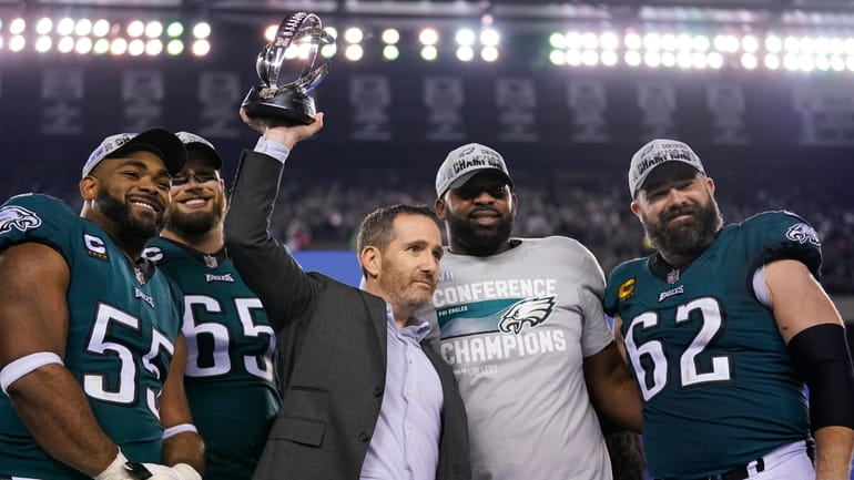 Philadelphia Eagles general manager Howie Roseman, center, stands with defensive...