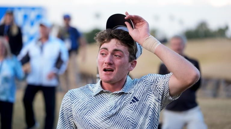 Nick Dunlap reacts after finishing on the 18th hole of...