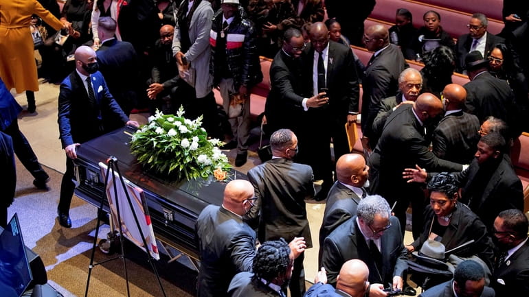 Tyre Nichols' casket is carried away after a funeral service...