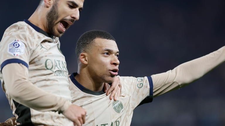PSG's Kylian Mbappe, right, celebrates after scoring his side's opening...
