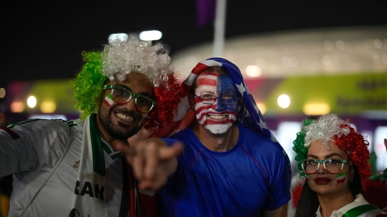 Iranian and US supporters pose for a photo before the...