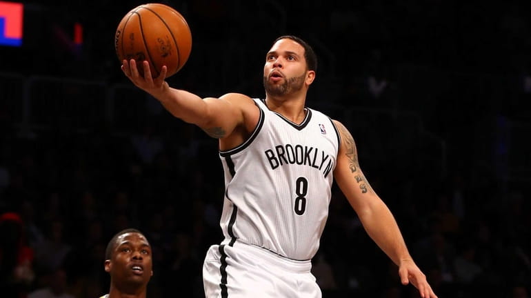 Deron Williams of the Brooklyn Nets lays up a basket...