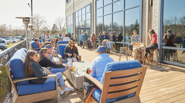 Patrons enjoy outdoor dining at Peconic County Brewing in Riverhead.