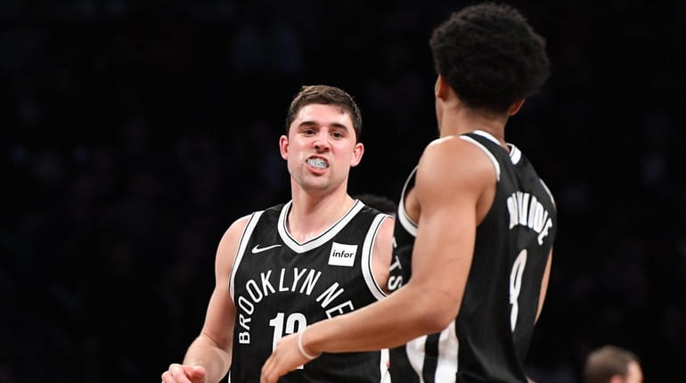 Nets guard Joe Harris is congratulated by Spencer Dinwiddie after...