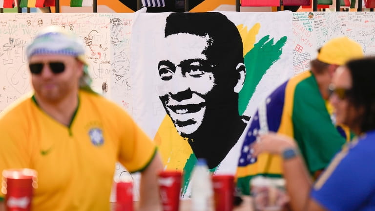 A portrait of Pelé is displayed at a Brazilian fan...