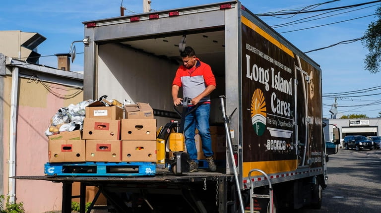 Kevin Avila unloads a truck outside Long Island Cares Essential...