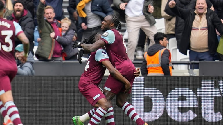 West Ham's Michail Antonio, right, celebrates with teammate Mohammed Kudus...