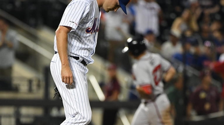 New York Mets relief pitcher Seth Lugo reacts on the...
