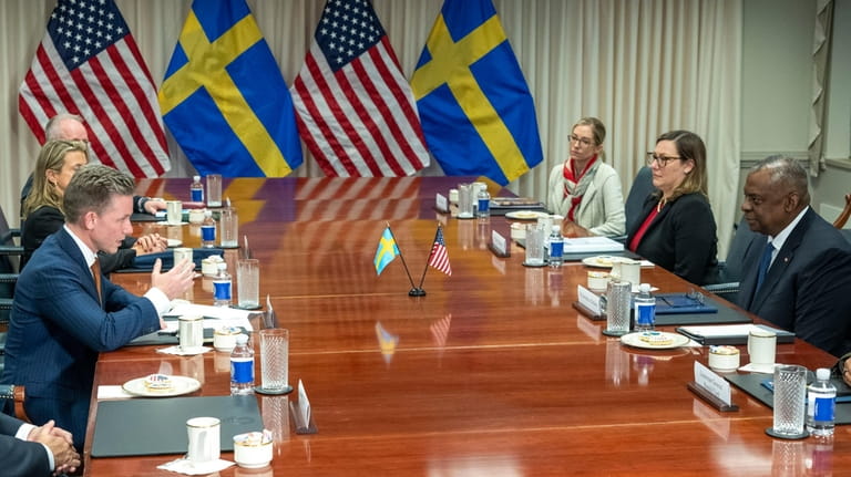 Swedish Defense Minister Pal Jonson, left, speaks during a meeting...