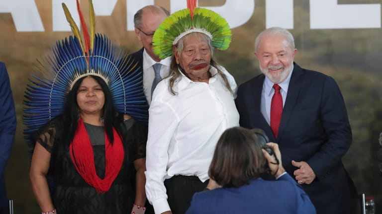 Brazilian President Luiz Inacio Lula da Silva, right, poses for...