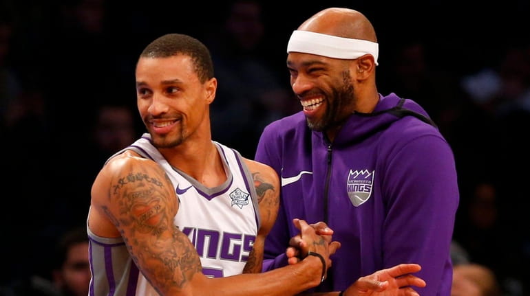 The Kings' Vince Carter has a laugh with teammate George...