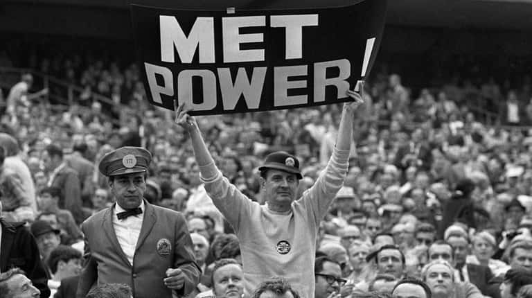 Mets fan Karl Ehrhardt, known as "Sign Man," holds up...
