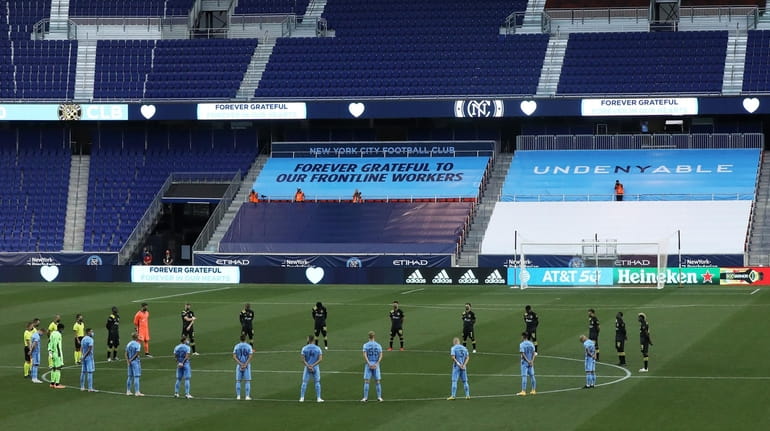 NYCFC and Columbus Crew stand during a moment of silence...