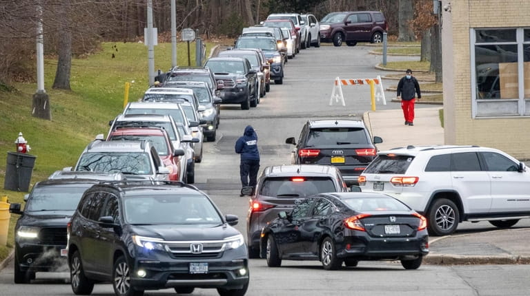 Cars were lined up Monday at Glen Cove High School...