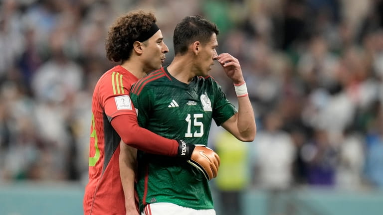 Mexico's goalkeeper Guillermo Ochoa embraces teammate Hector Moreno, right, at...