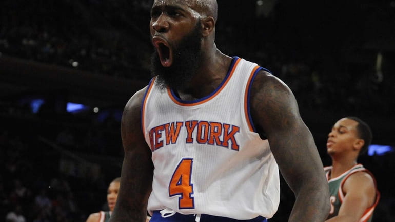 Knicks forward Quincy Acy reacts after sinking a basket against...