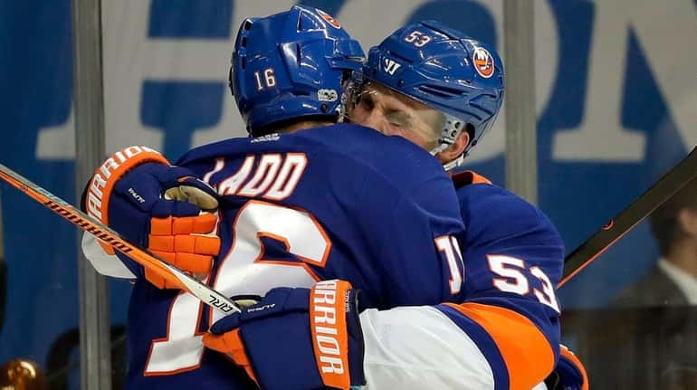 Islanders left wing Andrew Ladd celebrates with center Casey Cizikas...