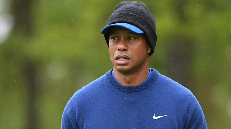 Tiger Woods looks on from the course during the first...