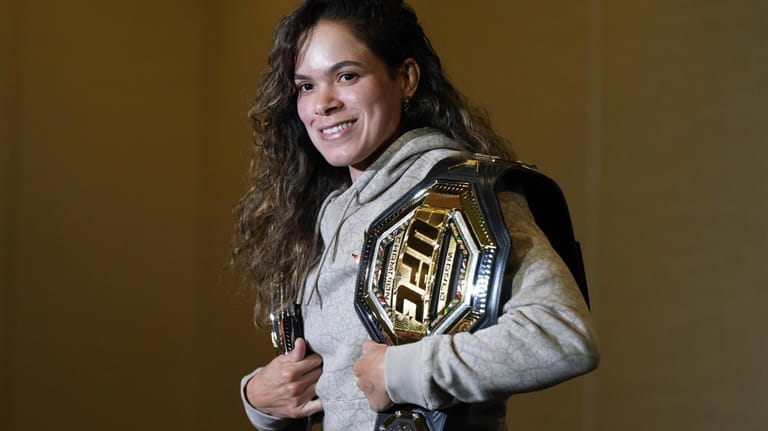Amanda Nunes poses for a photographs during a news conference...