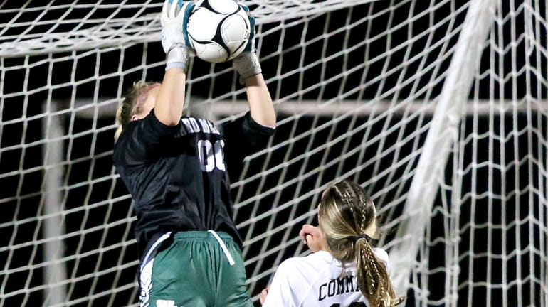 Ward Melville keeper Elyse Munoz makes the save with Commack...