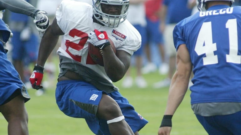 Running back Andre Brown breaks through the hole at Giants...