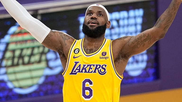 Lakers forward LeBron James celebrates after scoring to pass Kareem...