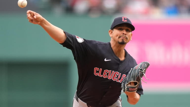 Cleveland Guardians' Carlos Carrasco delivers a pitch to a Boston...