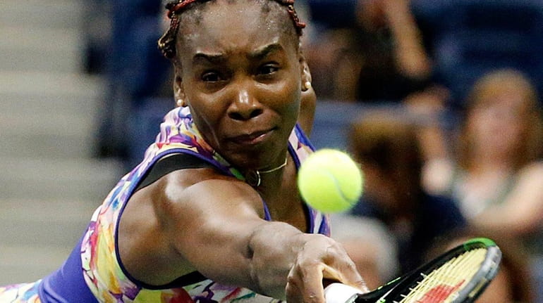 Venus Williams lunges for the backhand return against Julia Georges...