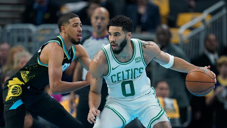 Boston Celtics' Jayson Tatum, right, is defended by Indiana Pacers'...