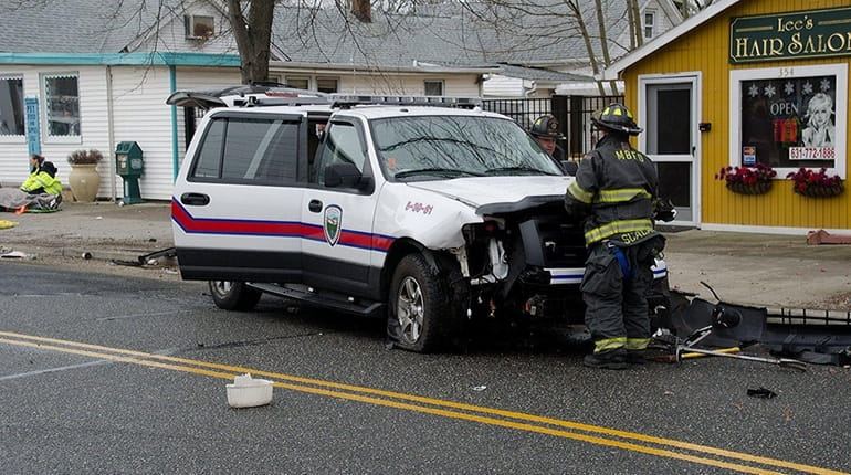 A firefighter at the scene of a crash involving a...