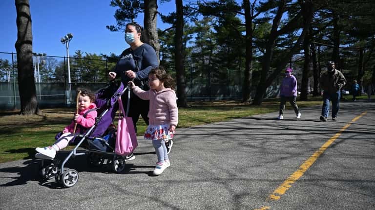 Julie Walz of Bellmore pushes daughter Liliana, 1, while daughter...