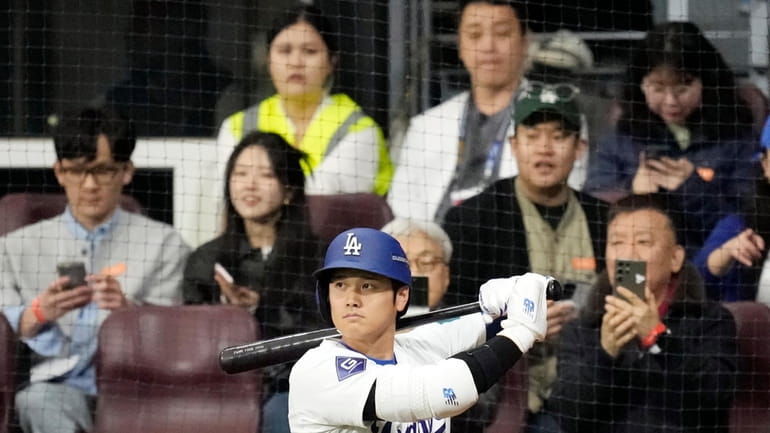 Los Angeles Dodgers' designated hitter Shohei Ohtani prepares to bat...