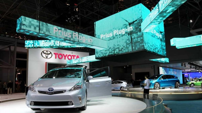 A Toyota Motor Corp. Prius V plug-in hybrid vehicle sits...