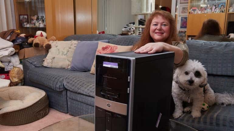 Alita Ditkowsky with her broken computer, which was fried after...