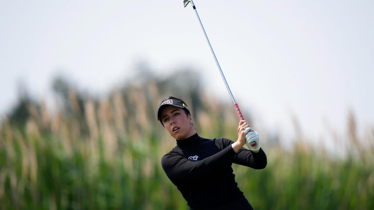 Georgia Hall, of England, watches her tee shot on the...