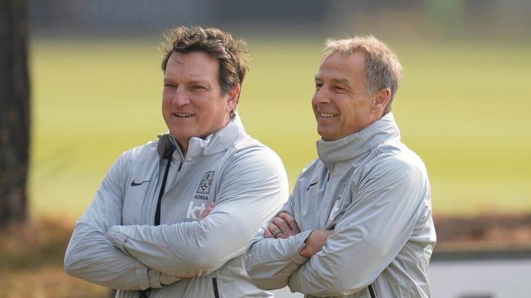 South Korea's new national team head coach Jurgen Klinsmann, right,...